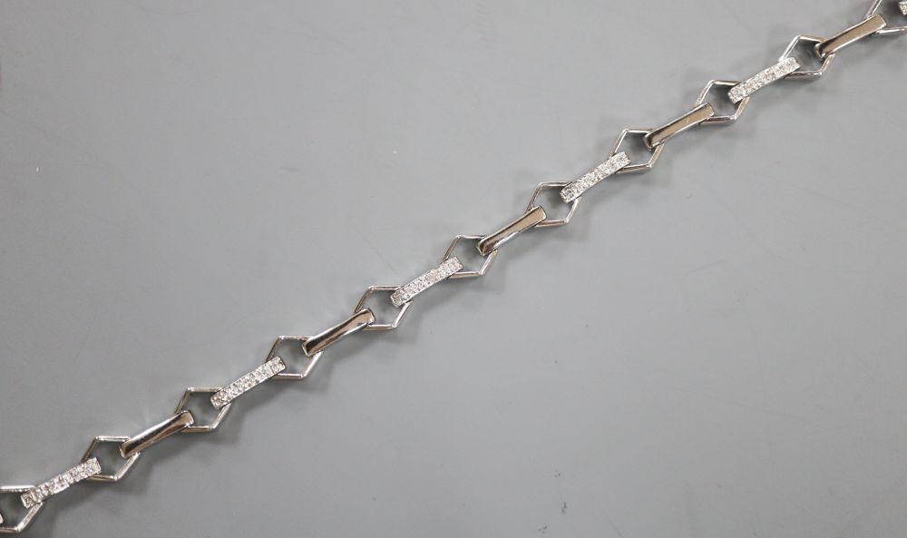 A modern 18k and diamond chip set baton and diamond shaped link line bracelet, 17.5cm, gross 9.5 grams.